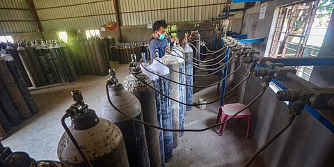 A technician refills medical oxygen cylinders in an industrial facility to supply to hospitals for the treatment of COVID-19 patients (Photo | PTI)