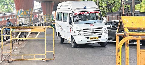 An ambulance makes its way through a roadblock during the statewide weekend lockdown, in Bengaluru on Saturday | Vinod Kumar T