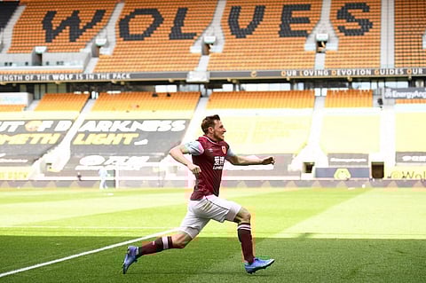 Burnley striker Chris Wood celebrates scoring his team's third goal during match against Wolverhampton Wanderers at the Molineux stadium, central England on April 25, 2021. (Photo | AFP)