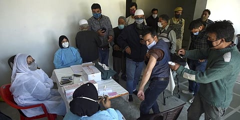 A man receives his COVID-19 vaccine jab in Srinagar on Sunday. (Photo | PTI)