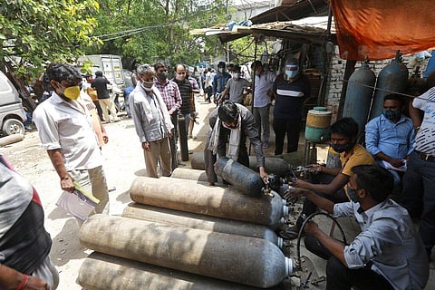 People stand in queues to refill oxygen in cylinders in New Delhi, India, Friday, April 23, 2021. (Photo | AP)