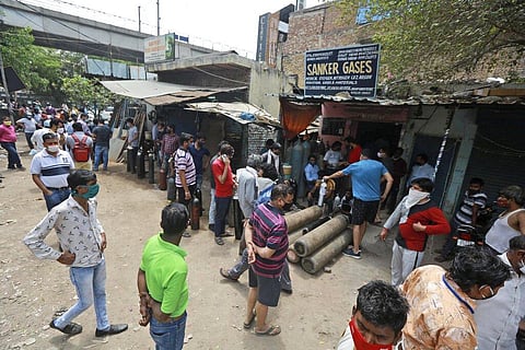 People stand in queues to refill oxygen in cylinders in New Delhi, India, Friday, April 23, 2021. (Photo | AP)