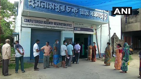 People queue up outside a polling booth in Murshidabad to cast their vote for the seventh phase of polls. (Photo | Twitter/ANI)
