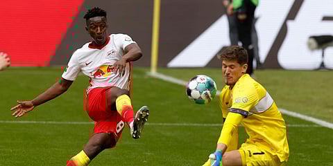 Leipzig's Amadou Haidara (L) scores the first goal of the game, past Stuttgart goalkeeper Gregor Kobel during a Bundesliga soccer match in Leipzig. (Photo| AP)