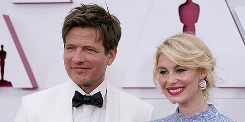 Thomas Vinterberg (L) and Helene Reingaard Neumann arrive at the Oscars. (Photo| AP)