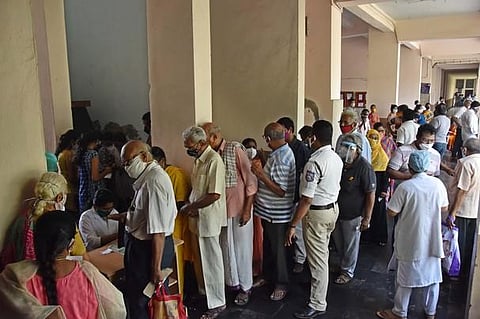 People stand in a queue for COVID vaccine at Siddhartha medical college in Vijayawada. (Photo | P Ravindra Babu, EPS)