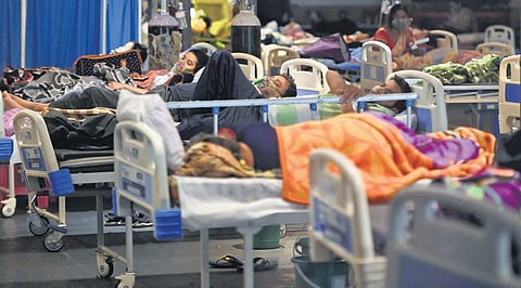 Patients inside a banquet hall that has been temporarily converted into a Covid-19 ward in New Delhi on Tuesday | AFp