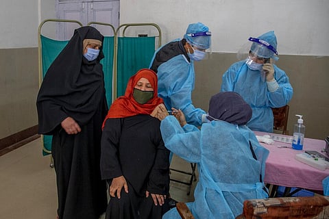 A Kashmiri woman receives COVISHIELD vaccine for COVID-19 at a primary health center in Srinagar, Indian controlled Kashmir, Wednesday, April 28, 2021. (Photo | AP)