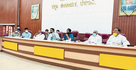 Deputy Chief Minister Laxman Savadi taking BIMS Director Dr Vinay Dastikop to task at a review meeting in Belagavi on Wednesday.| Express