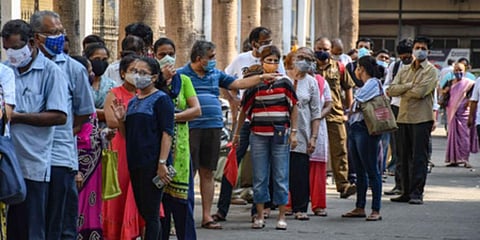 People stand in a queue to receive a dose of COVID-19 vaccine at Nair Hospital in Mumbai. (Photo | PTI)