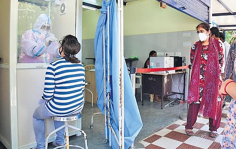 A health worker collects swab samples at CV Raman Hospital on Friday | SHRIRAM BN
