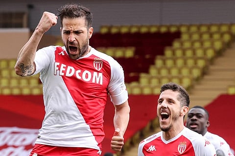 Monaco midfielder Cesc Fabregas (L) celebrates with teammates after scoring a goal against FC Metz at the 'Louis II' stadium in Monaco, on April 3, 2021. (Photo | AFP)