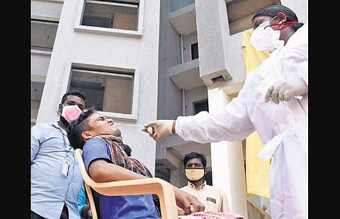 A health worker taking sample at a construction site in Egmore on Friday | R Satish Babu