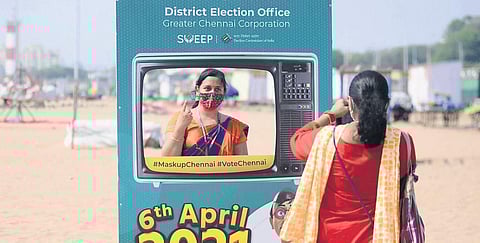 A woman getting her picture clicked while posing behind a voter awareness selfie point installed at Marina Beach in Chennai on Friday | DEBADATTA MALLICK