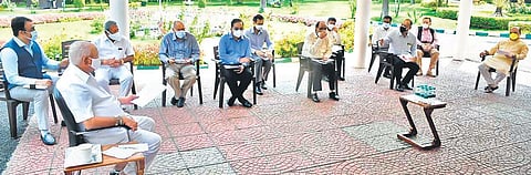 Chief Minister B S Yediyurappa holds a meeting outdoors with ministers and officials on Covid crisis, in Bengaluru on Thursday | Express