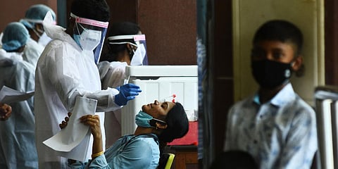 Swab samples being collected from the passengers' arrival terminal at Chennai airport . (Photo| Ashwin Prasath, EPS)