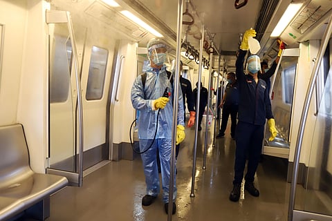 A worker sanitizes a coach of Chennai metro train. (Photo | Express)