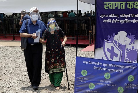 People wearing face shields and masks as a precaution against the coronavirus arrive to receive COVID-19 vaccine in Mumbai. (Photo | AP)
