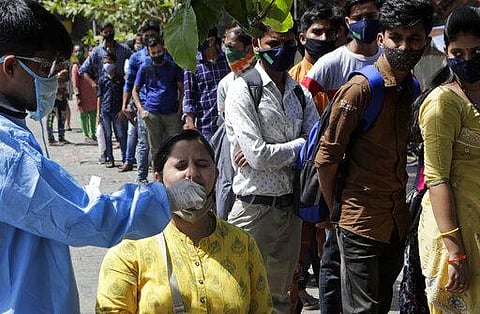 A health worker takes a nasal swab sample to test for COVID-19 near the landmark Gateway of India in Mumbai. (Photo | AP)
