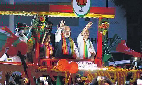 Amit Shah waves at party workers during a roadshow organised by the NDA as part of the campaign for the front’s candidates Navya Haridas, MT Ramesh, VK Sajeevan, in Kozhikode on Saturday | TP Sooraj