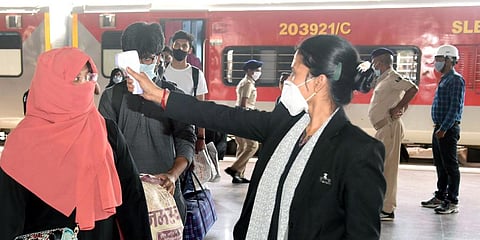 Passengers undergo thermal screening at Patna Junction railway station. (Photo | ANI)
