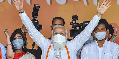 PM Narendra Modi waves at crowd during an election campaign rally in support of BJP candidates at Dumujola Stadium in Howrah district, Tuesday, April 6, 2021. (Photo | PTI)