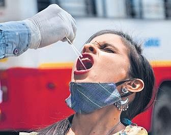 A health worker collects a sample from a passenger at Majestic Bus Terminus on Monday |ASHISH KRISHNA HP