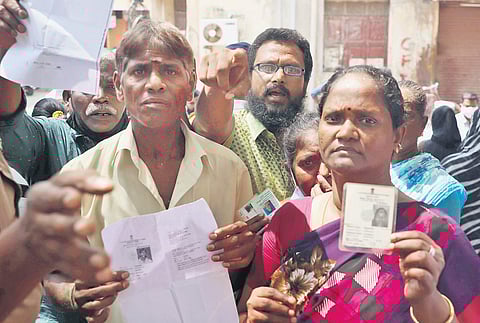 Residents of Harbour constituency showing their identity cards after they were not allowed to vote at Measi School booth | Sri Loganathan V