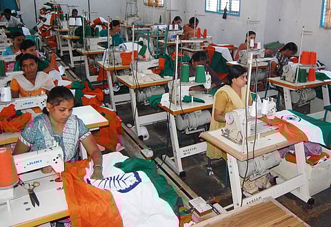 Women workers make national flags at the Bengeri khadi unit in Hubballi. (Photo | D Hemanth, EPS)