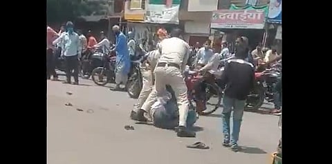Two police officers seen beating up a man in Indore. (Photo | @GauravPandhi, Twitter)