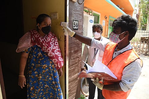 A healthcare worker conducts thermal screening on a woman in Chennai as coronavirus cases surge. (Photo | R Satish Babu, EPS)