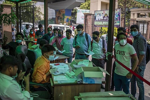 People wait to test for COVID-19 at a government hospital in Noida, a suburb of New Delhi. (Photo | AP)