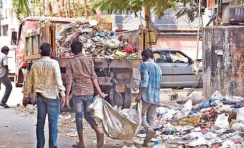 GHMC sanitation workers pick up garbage without safety gear in Hyderabad. (Photo| EPS/RVK Rao)