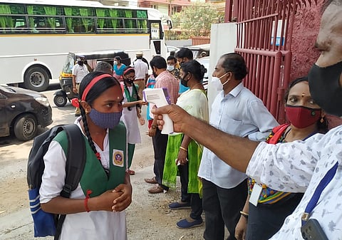 Students undergoing thermal screening at Cottonhill GHSS, Thiruvananthapuram.(Photo | B P Deepu, EPS)