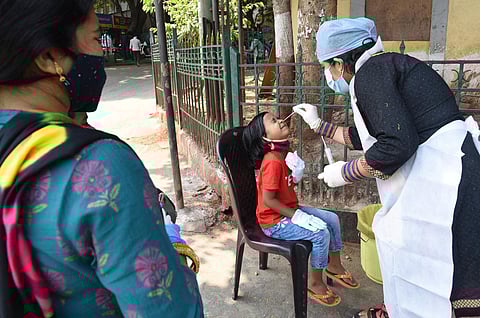 Health worker collecting swab samples at KSR Railway station, in Bengaluru. (Photo | Vinod Kumar T, EPS)