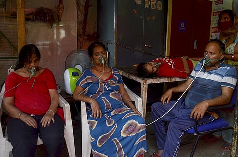 COVID-19 patients receive oxygen outside a Gurdwara, a Sikh house of worship, in New Delhi. (Photo | AP)