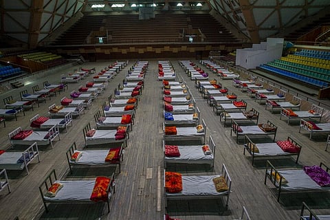 Beds lie inside an indoor stadium converted into COVID-19 treatment center for emergencies in the wake of the spike in the numbers of positive coronavirus cases in Srinagar. (Photo | AP)