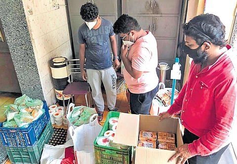 Satish Savitri Sarella packing food for the Covid-19 patients I Express