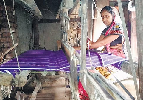 A weaver working at a loom in a village in Kendrapara district | Express