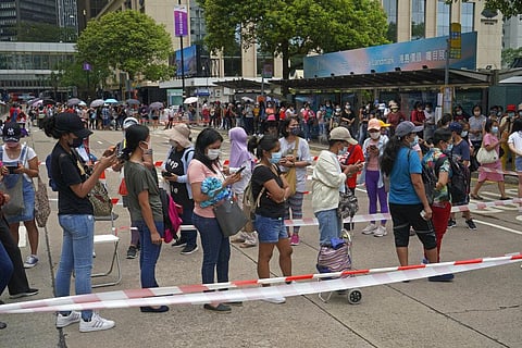 Domestic helpers from the Philippines line up at the temporary testing center for COVID-19, in Hong Kong. (Photo | AP)