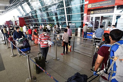Passengers lineup to check-in outside the Indira Gandhi International airport. (File Photo | AFP)