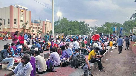 Scores of migrant workers wait outside the Secunderabad Railway Station to head back to their native areas in other States, on Wednesday. (Photo | Express)