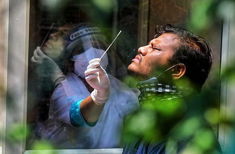 Health officers collect swab samples for COVID-19 tests amid surge in coronavirus cases. (Photo | Shriram BN, EPS)