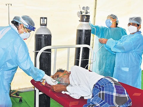 Wearing PPE kit, nurses at Padmavathi Covid Hospital in Tirupati serve a Covid-19 patient on Wednesday, rededicating themselves to their profession on the occasion of International Nurses Day | Madhav