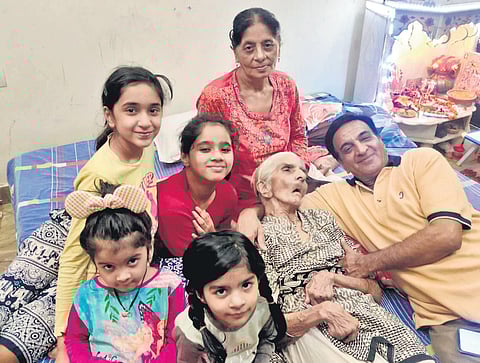 The 96-year-old Pushpa Sharma poses with family at her Shahdara residence in New Delhi | PTI
