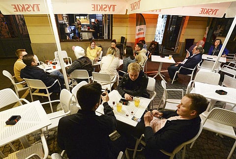 People gather and celebrate as bars, clubs and other establishments reopened in Poland after being closed for seven months, in Warsaw, Poland. (Photo | AP)