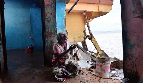 A fisherwoman prays after her house got destroyed in sea attack at Thiruvananthapuram. (Photo | Vincent Pulickal, EPS)