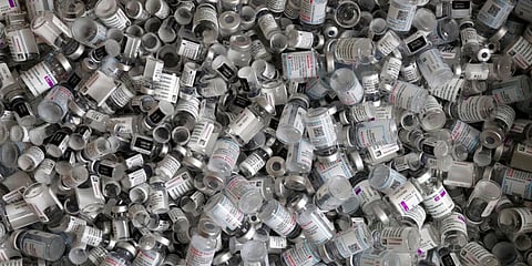 Empty vials of the Pfizer-BioNTech, Moderna and AstraZeneca COVID-19 vaccine lie in a box during a vaccine campaign. (Photo | AP)