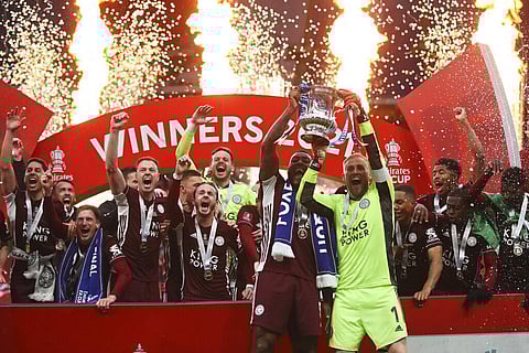 Leicester's goalkeeper Kasper Schmeichel, right, and Wes Morgan lift the trophy after winning the FA Cup final soccer match between Chelsea and Leicester City (Photo | AP)