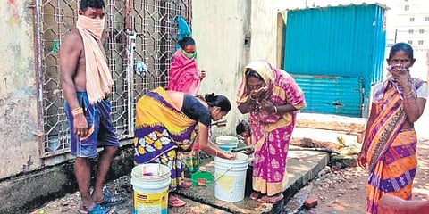 People using a common drinking water post at Dagbar Sahi in Cuttack. (Photo | EPS)